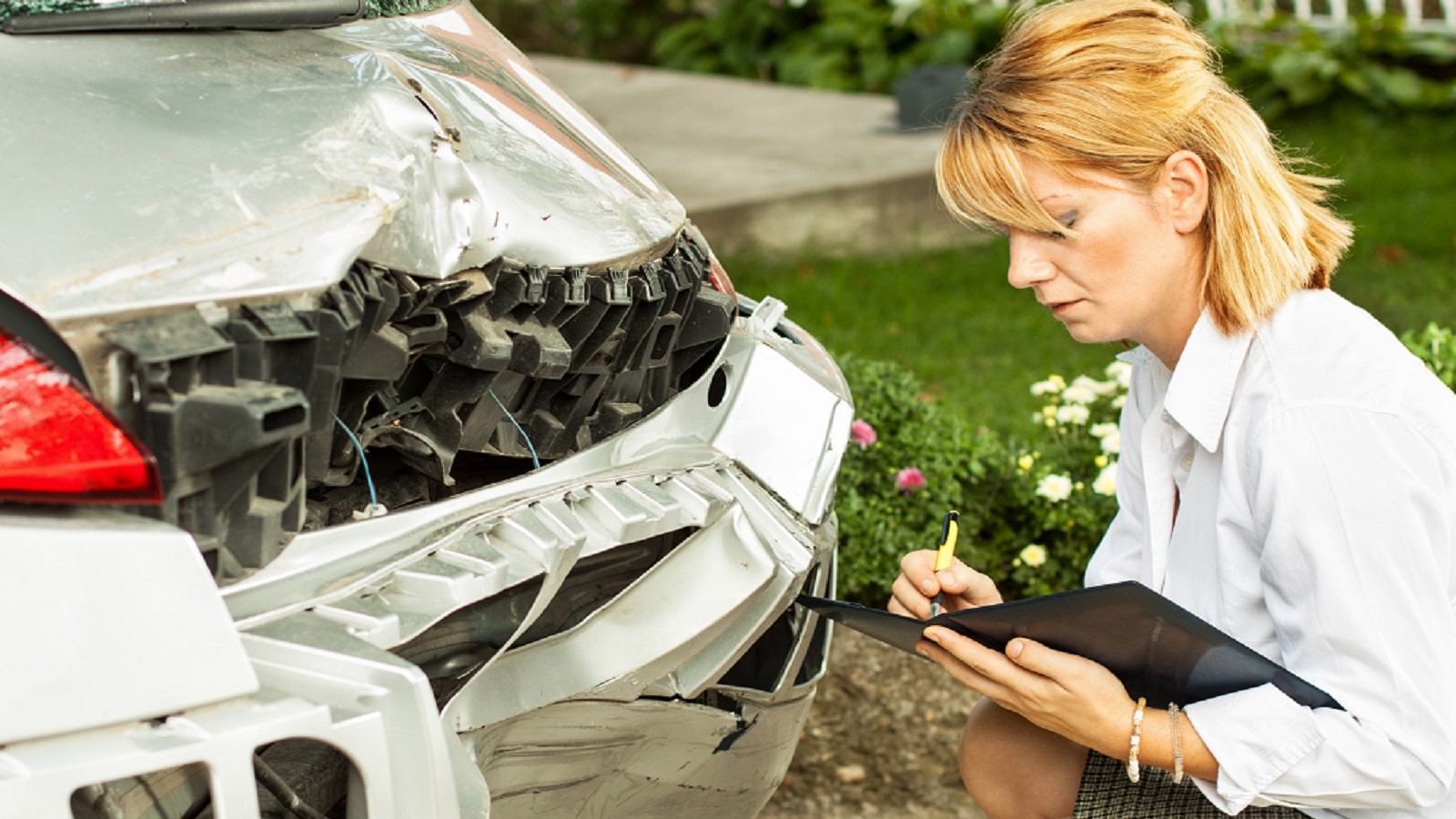 Insurance Adjuster Examining SUV Stock Photo
